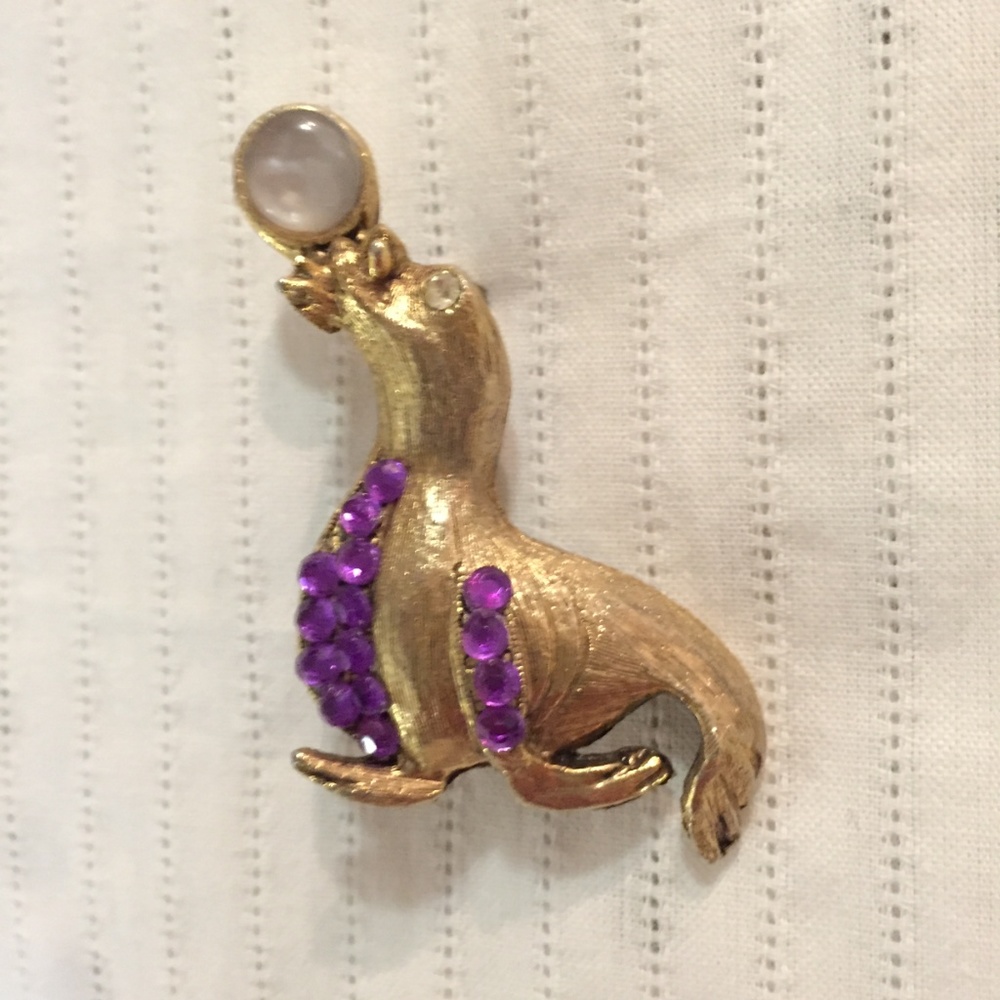Vintage gold-tone seal pin with purple gems